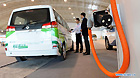 A visitor looks at a battery-driven vehicle during the 2011 China International New Energy Vehicles Industry Promotion Week in Beijing, capital of China, Oct. 13, 2011.