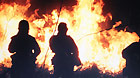 Firemen put out forest fire in Hegang, northeast China's Heilongjing Province, on Oct. 12, 2011.