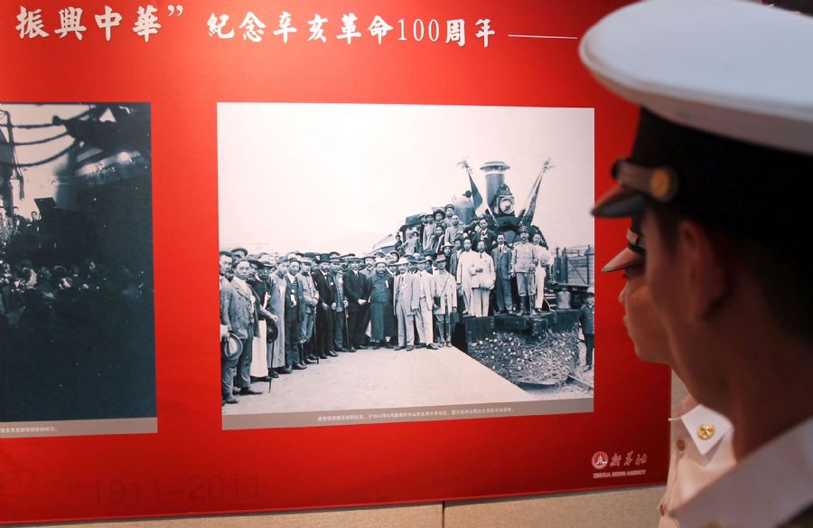 Navy sailors watch a photo show to commemorate the 100th anniversary of the 1911 (Xinhai) Revolution in Shanghai, east China, Oct. 19, 2011. The photo show displayed over 200 pictures related to the 1911 Revolution.