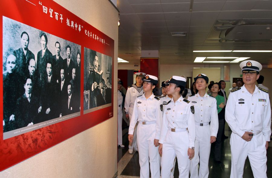 Navy sailors watch a photo show to commemorate the 100th anniversary of the 1911 (Xinhai) Revolution in Shanghai, east China, Oct. 19, 2011. The photo show displayed over 200 pictures related to the 1911 Revolution.