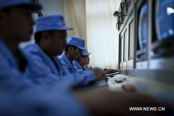 Technicians operate optical monitoring equipments at the Taiyuan Satellite Launch Center in Taiyuan, capital of north China&apos;s Shanxi Province, Nov. 8, 2011. 
