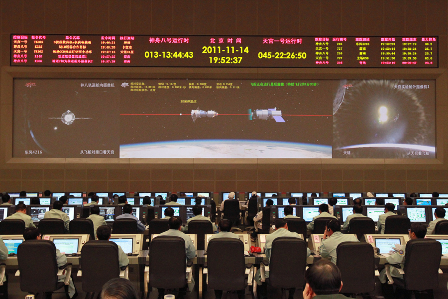 Staff members work in the Beijing Aerospace Flight Control Center in Beijing, capital of China, Nov. 14, 2011. China&apos;s Shenzhou-8 unmanned spacecraft successfully re-docked with the Tiangong-1, a module of the country&apos;s planned space lab on Monday.