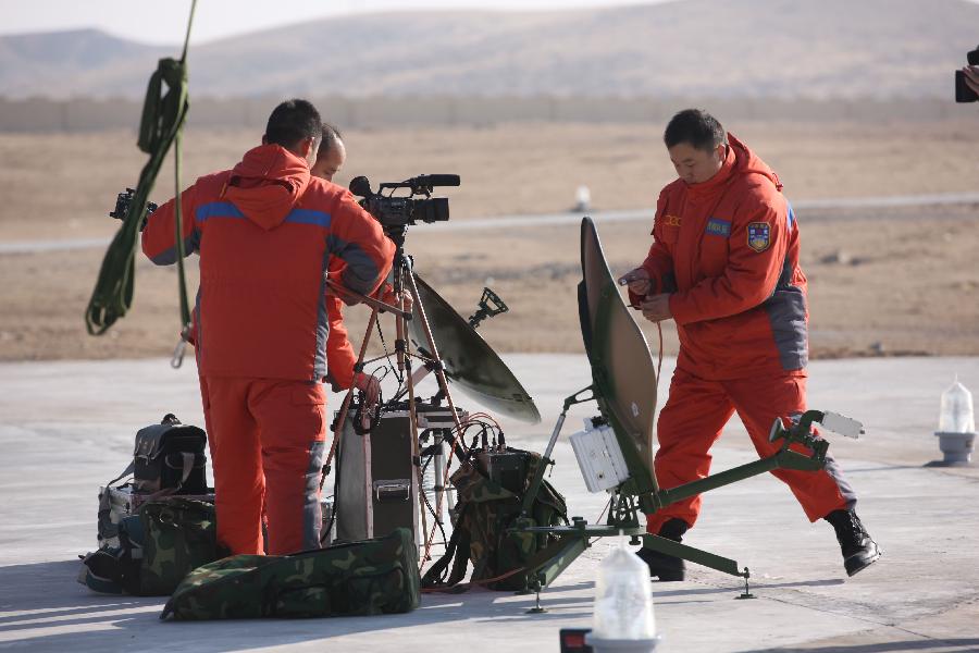 Searchers hold a rehearsal of searching and retrieving the Shenzhou 8 unmanned spacecraft in the main landing field in north China&apos;s Inner Mongolia Autonomous Region, Nov. 16, 2011. 