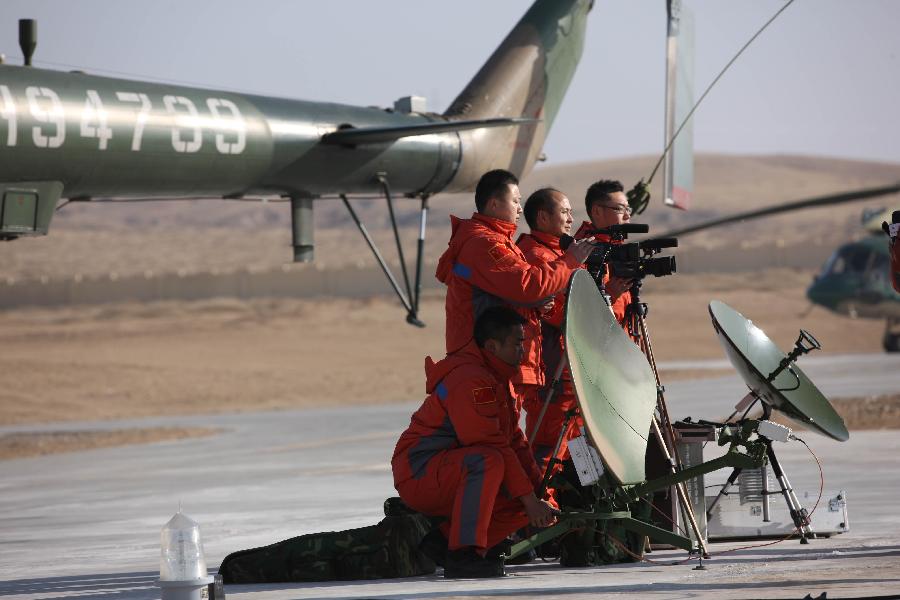 Searchers hold a rehearsal of searching and retrieving the Shenzhou 8 unmanned spacecraft in the main landing field in north China&apos;s Inner Mongolia Autonomous Region, Nov. 16, 2011. 