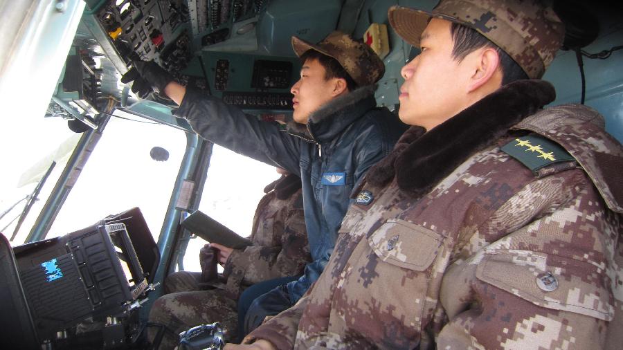 Members of an aerial search team hold a rehearsal in a helicopter for the return of the Shenzhou 8 unmanned spacecraft in the main landing field in north China&apos;s Inner Mongolia Autonomous Region, Nov. 16, 2011. 