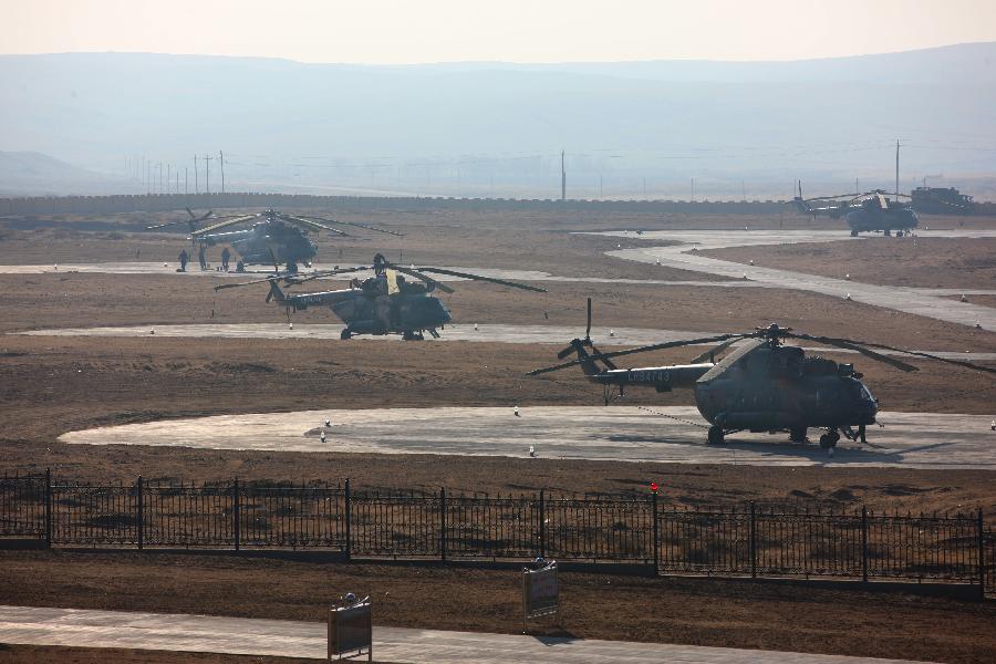 Helicopters of aerial search teams stand by for the searching of the Shenzhou 8 unmanned spacecraft in the main landing field in north China&apos;s Inner Mongolia Autonomous Region, Nov. 16, 2011. 