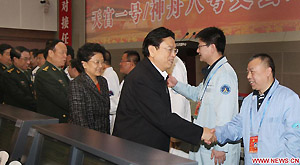 Chinese senior officials including Vice Premier Zhang Dejiang, State Councilor Liu Yandong, vice chairmen of the Central Military Commission Guo Boxiong and Xu Caihou, all of whom are members of the Political Bureau of the Communist Party of China (CPC) Central Committee, congratulate aerospace engineers after watching live broadcast of the return of the Shenzhou-8 unmanned spacecraft at the Beijing Aerospace Flight Control Center in Beijing, capital of China, Nov. 17, 2011.
