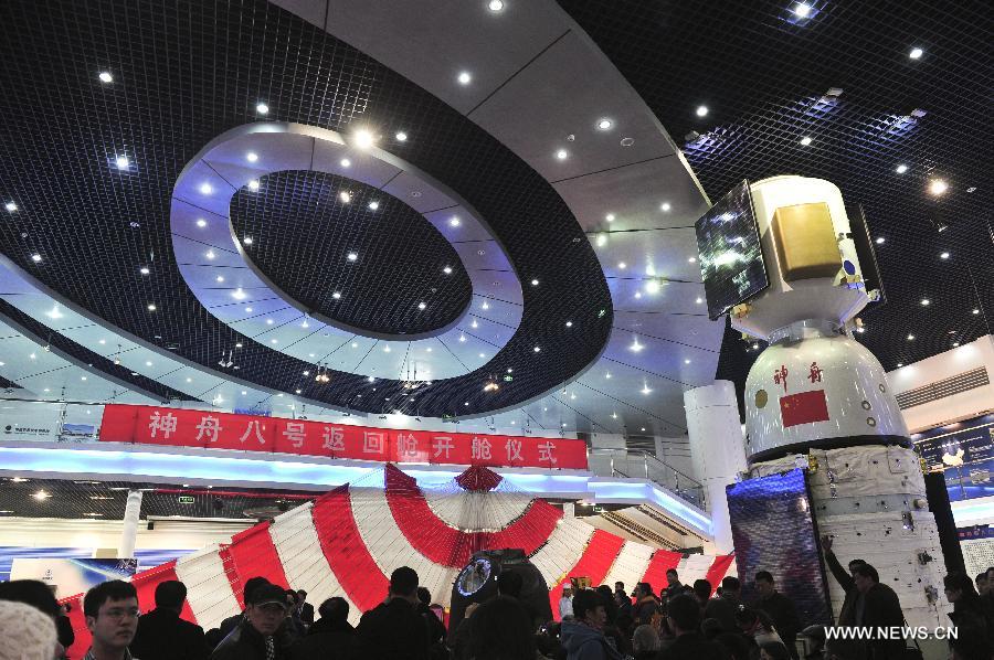 Photo taken on Nov. 21, 2011 shows the scene of a ceremony, at which the re-entry capsule of China&apos;s unmanned spacecraft Shenzhou-8 will be opened, in Beijing, capital of China.