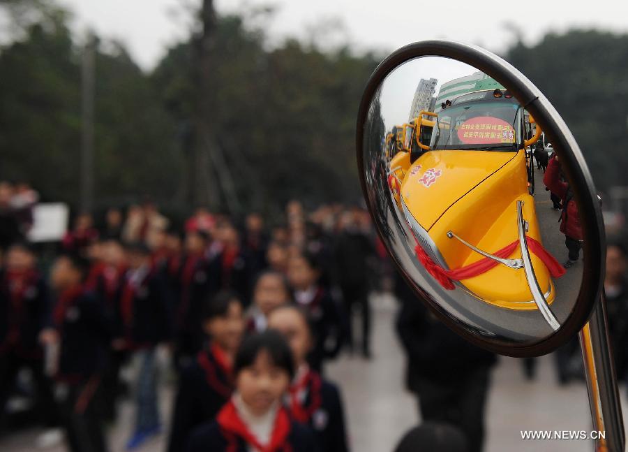 Photo taken on Nov. 22, 2011 shows inverted image of a new school bus in Chongqing, southwest China.