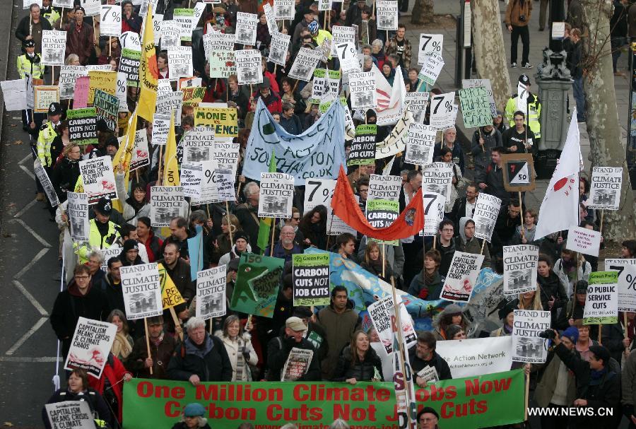 Protestors march during a climate change demonstration in central London, Britain, Dec. 3, 2011. Hundreds of environmentalists marched in central London to protest that 7% of the world&apos;s richest population produce 50% of the world&apos;s carbon emissions. 