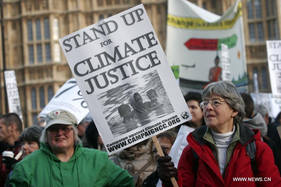 Protestors march during a climate change demonstration in central London, Britain, Dec. 3, 2011.