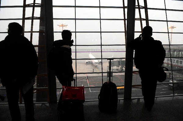 Passengers wait to board their flights at Capital International Airport in Beijing, capital of China, Dec. 5, 2011.