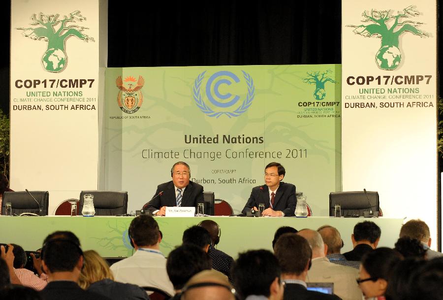 Xie Zhenhua (L), deputy director of the National Development and Reform Commission and head of the Chinese delegation, addresses a news conference in Durban, South Africa, on Dec. 5, 2011. 
