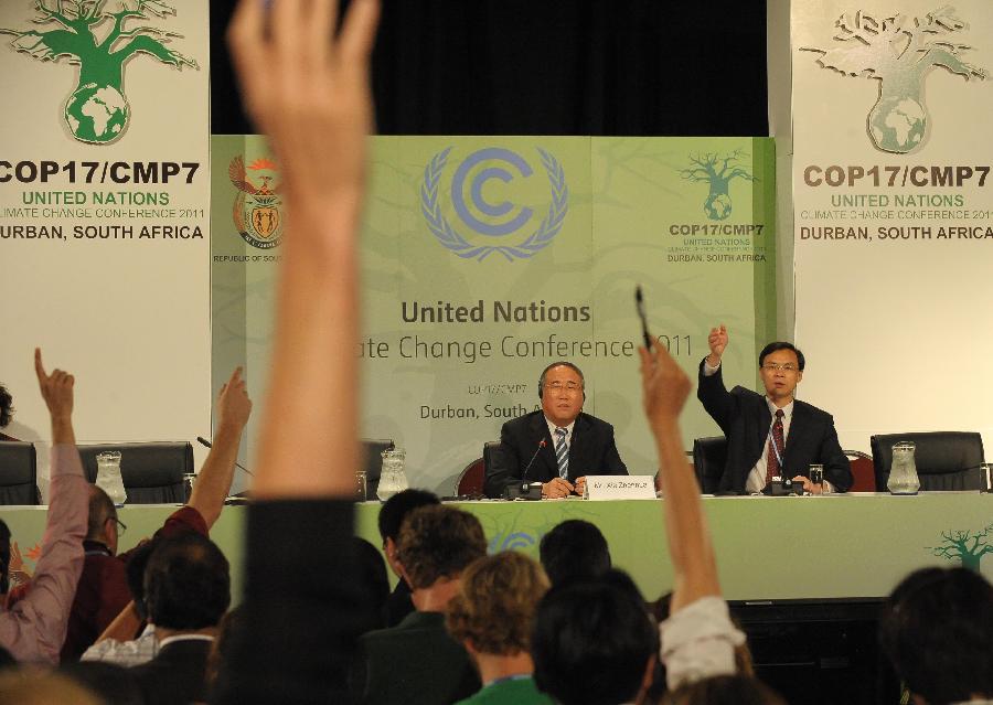 Xie Zhenhua (L), deputy director of the National Development and Reform Commission and head of the Chinese delegation, addresses a news conference in Durban, South Africa, on Dec. 5, 2011. 