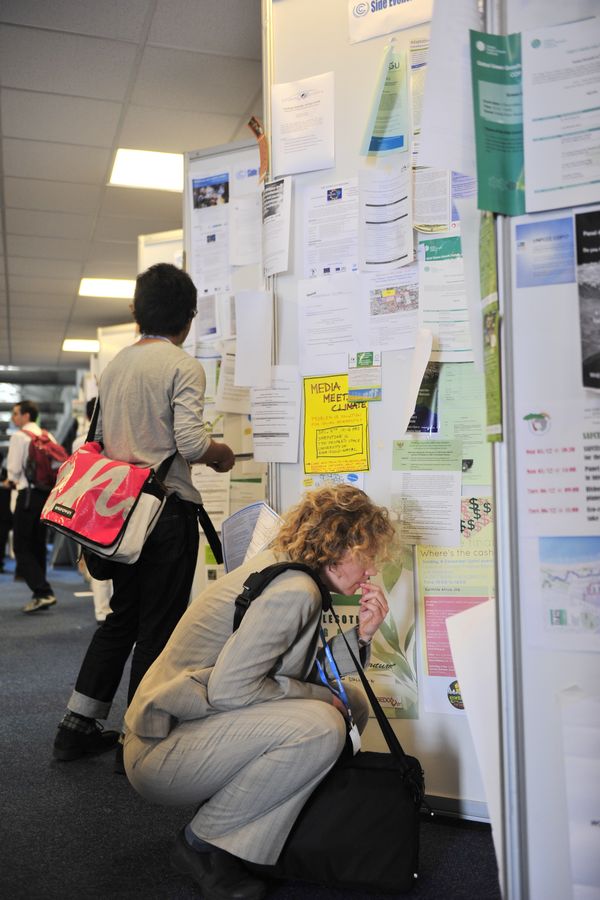 A Durban climate talk delegate is reading the notice board. [China.org.cn]