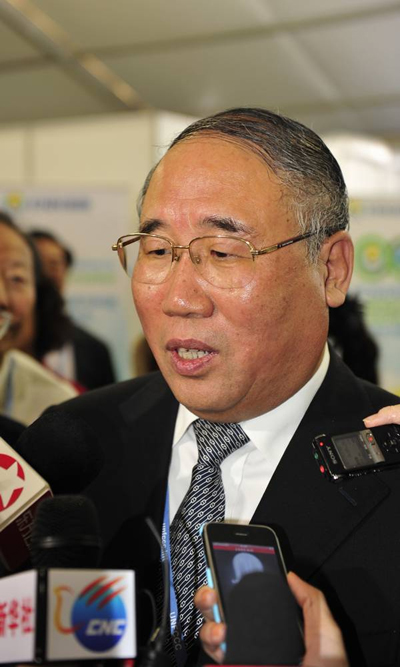 Xie Zhenhua, deputy director of the National Development and Reform Committee, speaks with reporters.