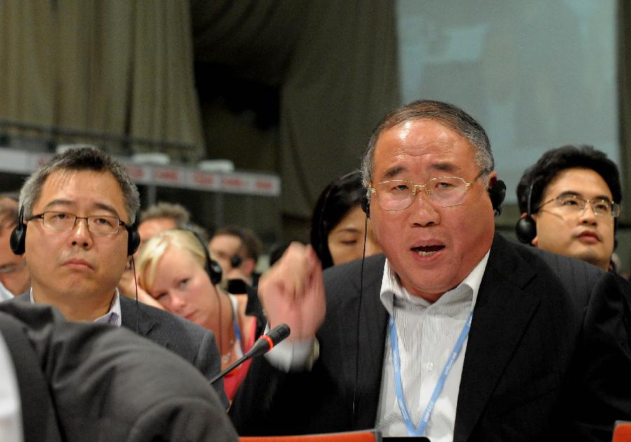 Xie Zhenhua (R), vice director of China&apos;s National Development and Reform Commission and head of the Chinese delegation, addresses the plenary session of the UN Climate Conference (COP17) in Durban, South Africa, Dec. 11, 2011.
