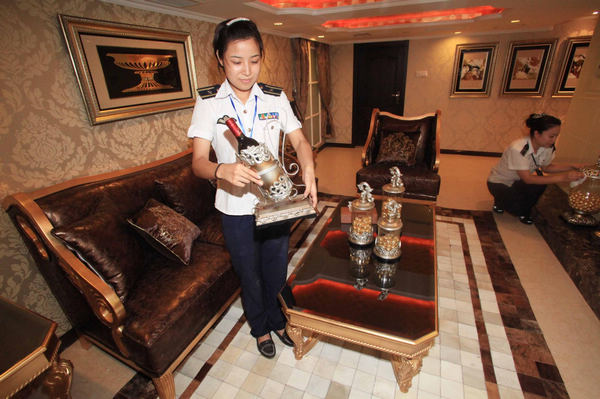 Two attendants clean the Presidential suite of the Tianjin Aircraft Carrier Hotel in Tianjing on August 8, 2011. 