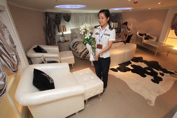 Two attendants clean the Presidential suite of the Tianjin Aircraft Carrier Hotel in Tianjing on August 8, 2011. 
