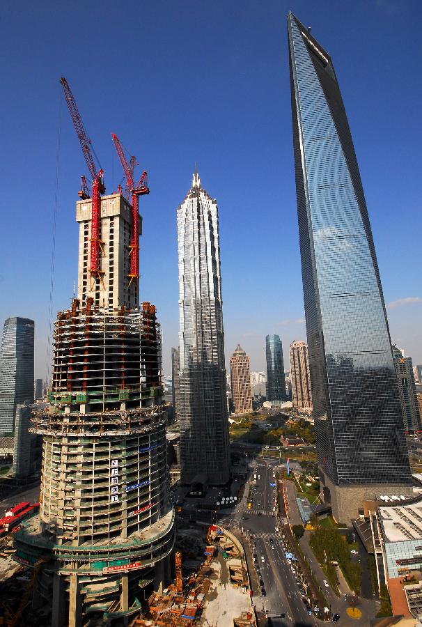 Photo taken on Jan. 17, 2012 shows the Shanghai Tower (L) under construction alongside the Jin Mao Tower and Shanghai World Financial Center in Shanghai, east China