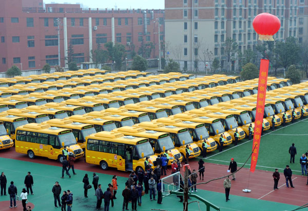 A fleet of new school buses park in rows at a primary school in Nanjing, Feb 6, 2012. 