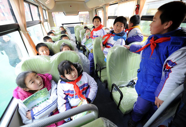 Students of a local primary school take a ride on their new school bus, Feb 6, 2012. 