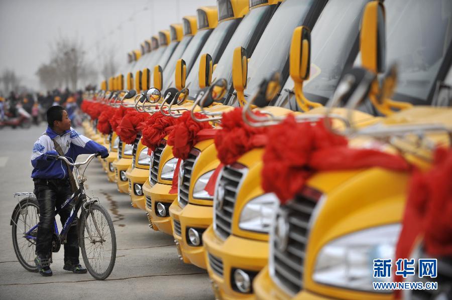 A student takes a closer look at Zhongwei No.6 Middle School&apos;s new American-style school buses on Feb. 23, 2012.