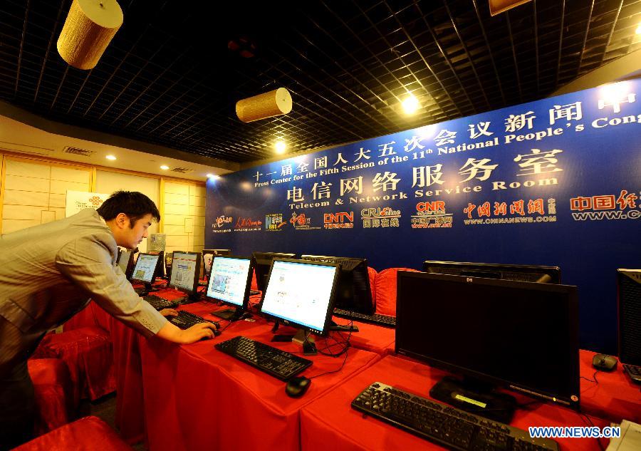 A technician debugs network in the Press Center for 'Lianghui', namely the two annual sessions of the National People's Congress (NPC) and the National Committee of Chinese People's Political Consultative Conference (CPPCC), in Beijing, capital of China, Feb. 26, 2012.