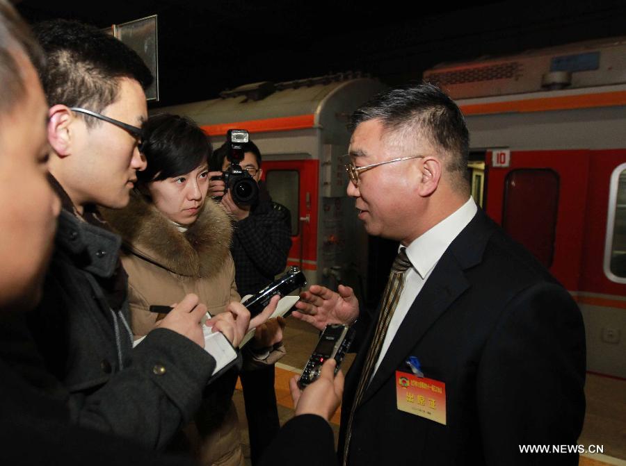 Si Fuchun (1st R), a member of the 11th National Committee of the Chinese People's Political Consultative Conference (CPPCC) from central China's Henan Province, speaks to journalists as he arrives in Beijing, capital of China, March 1, 2012. 