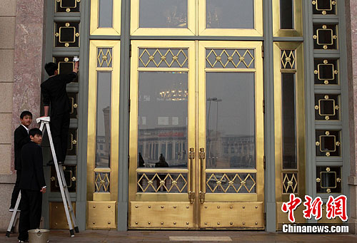 Staff cleans the gate of the Great Hall of the People on Feb. 29, 2012, in preparation for Lianghui, the annual conferences of China's central legislative bodies. 