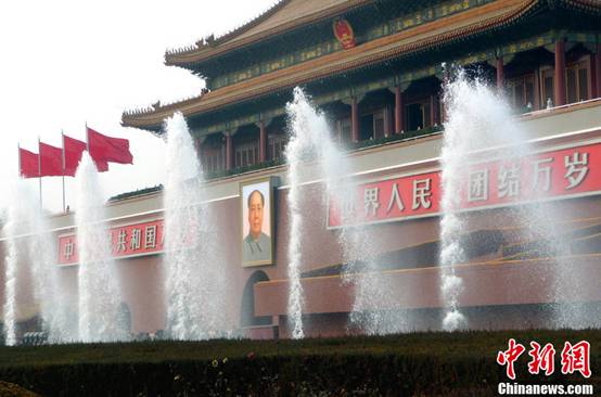 Fountains spring up high in front of the Tiananmen rostrum in Beijing, Feb. 28, 2012. 