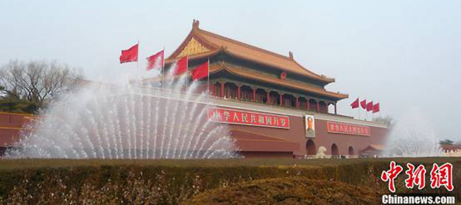 Fountains spring up high in front of the Tiananmen rostrum in Beijing, Feb. 28, 2012.