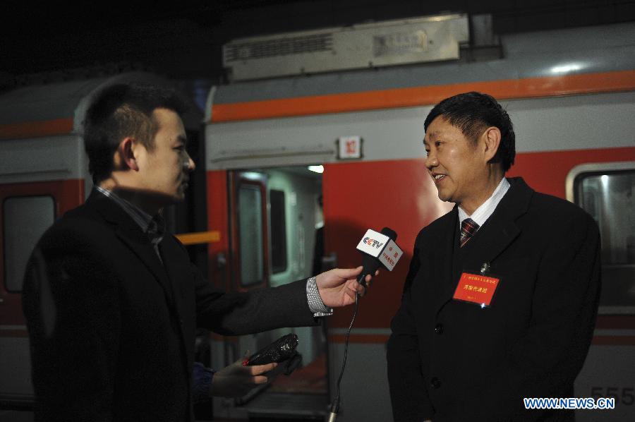 Liu Guoqing (R), a deputy to the Fifth Session of the 11th National People's Congress (NPC) from central China's Henan Province, speaks to journalists as he arrives in Beijing, capital of China, March 2, 2012.