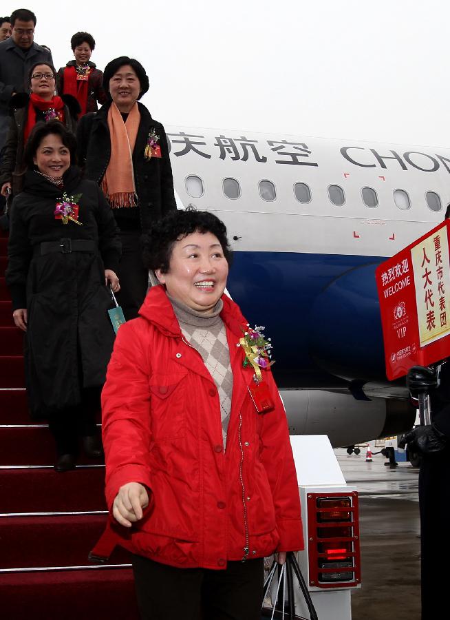 Deputies to the Fifth Session of the 11th National People's Congress (NPC) from southwest China's Chongqing Municipality arrive in Beijing, capital of China, March 2, 2012. 