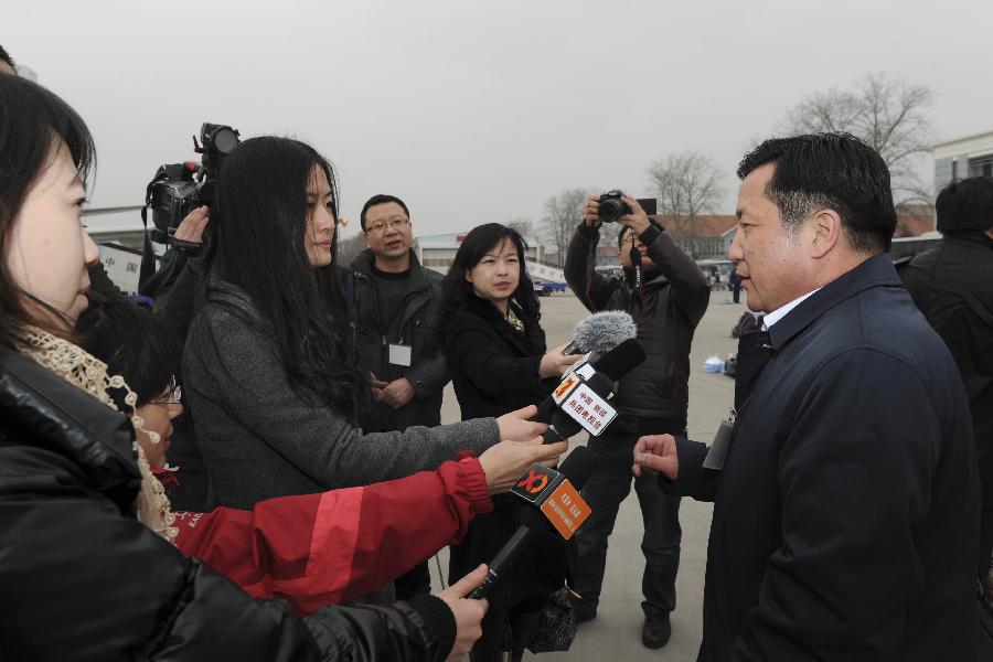 A deputy to the Fifth Session of the 11th National People's Congress (NPC) from northwest China's Xinjiang Uygur Autonomous Region speaks to journalists as he arrives in Beijing, capital of China, March 2, 2012. 