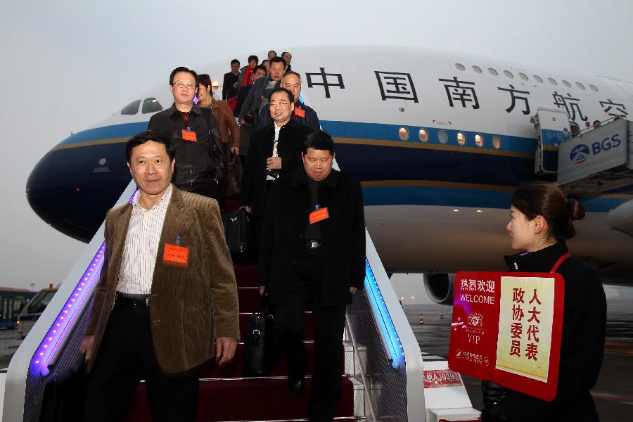 Deputies to the Fifth Session of the 11th National People's Congress (NPC) and members of the 11th National Committee of the Chinese People's Political Consultative Conference (CPPCC) from south China's Guangdong Province arrive in Beijing, capital of China, March 2, 2012. 