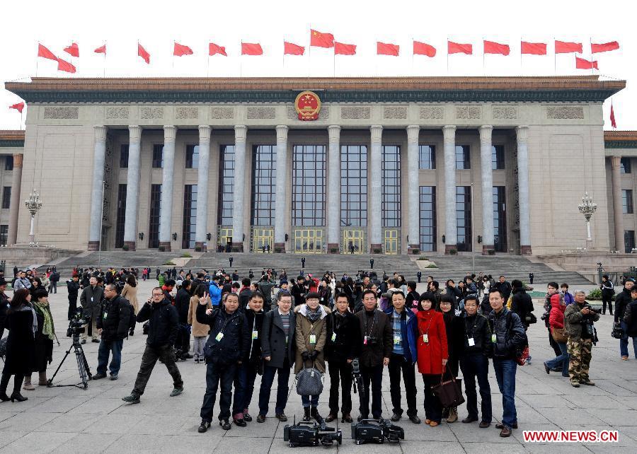 Journalists to the Fifth Session of the 11th National Committee of the Chinese People's Political Consultative Conference (CPPCC) pose for a group photo outside the Great Hall of the People in Beijing, capital of China, March 3, 2012. 