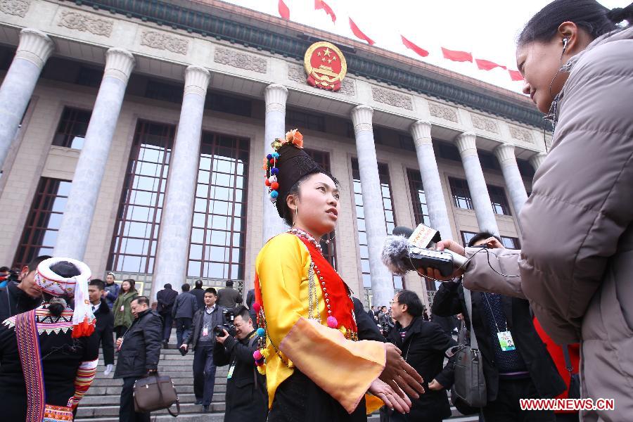 Liang Xiaodan, a member of the 11th National Committee of the Chinese People's Political Consultative Conference (CPPCC), speaks to a journalist prior to the CPPCC session at the Great Hall of the People in Beijing, capital of China, March 3, 2012. 