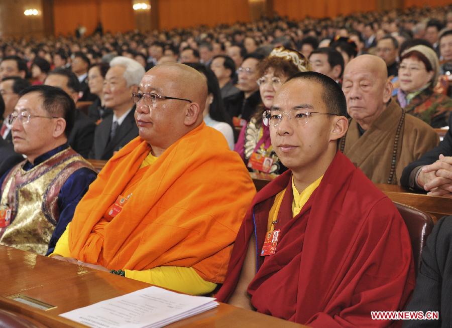 The 11th Panchen Lama Bainqen Erdini Qoigyijabu (R, front), a member of the 11th National Committee of the Chinese People's Political Consultative Conference (CPPCC), attends the Fifth Session of the 11th CPPCC National Committee at the Great Hall of the People in Beijing, capital of China, March 3, 2012. 