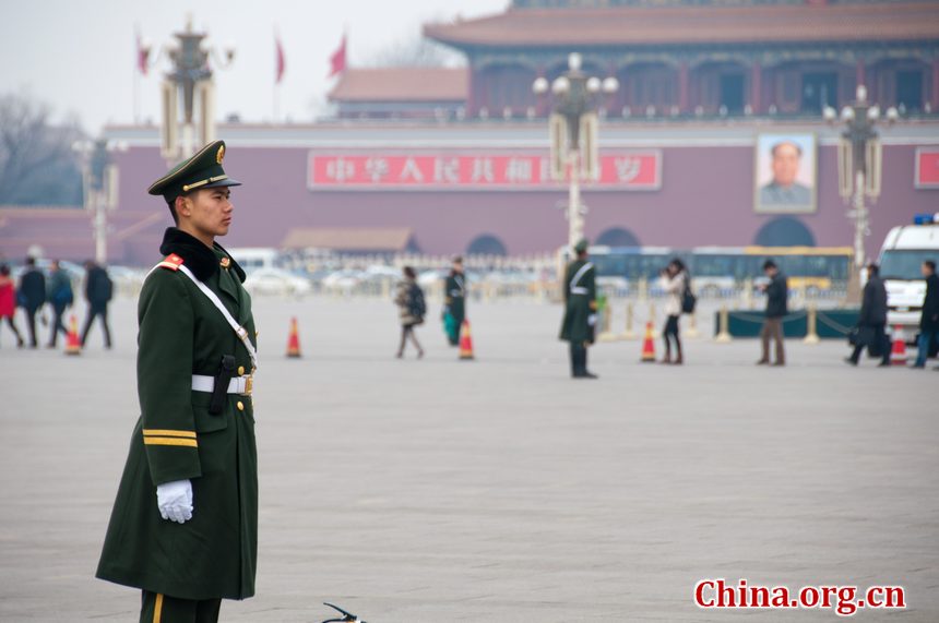 A solider stands on guard in Tian'anmen Square shortly before the opening ceremony of CPPCC takes place on Saturday afternoon. [China.org.cn]