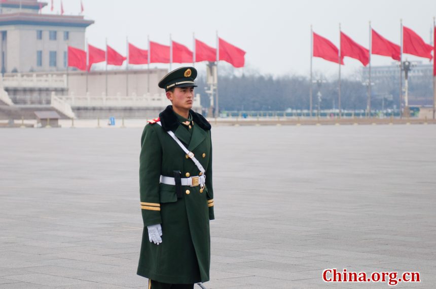 A solider stands on guard in Tian'anmen Square shortly before the opening ceremony of CPPCC takes place on Saturday afternoon. [China.org.cn]