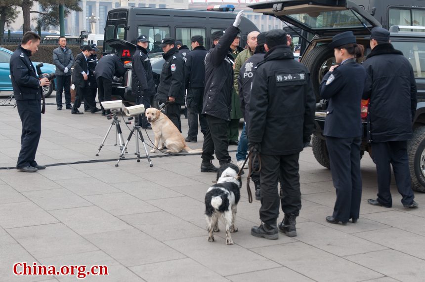 Police officers check the journalists' vehicles as they enter a special parking section in Tian'anmen Square before the openining ceremony of CPPCC opens on Saturday afternoon at the Great Hall of the People in Beijing, China. [China.org.cn]