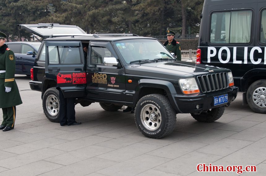 Police officers check the journalists' vehicles as they enter a special parking section in Tian'anmen Square before the openining ceremony of CPPCC opens on Saturday afternoon at the Great Hall of the People in Beijing, China. [China.org.cn]