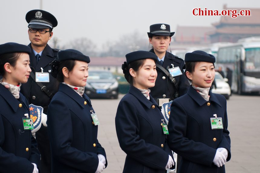 Hotel staff members serving the delegations to the National People's Congress (NPC) pose for photos at the Tian'anmen Square on Sunday, March 4, 2012, in Beijing, China, one day prior to the NPC's opening ceremony on the morning of March 5 at the Great Hall of the People. [China.org.cn]