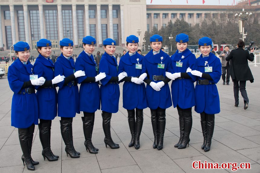 Hotel staff members serving the delegations to the National People's Congress (NPC) pose for photos at the Tian'anmen Square on Sunday, March 4, 2012, in Beijing, China, one day prior to the NPC's opening ceremony on the morning of March 5 at the Great Hall of the People. [China.org.cn]