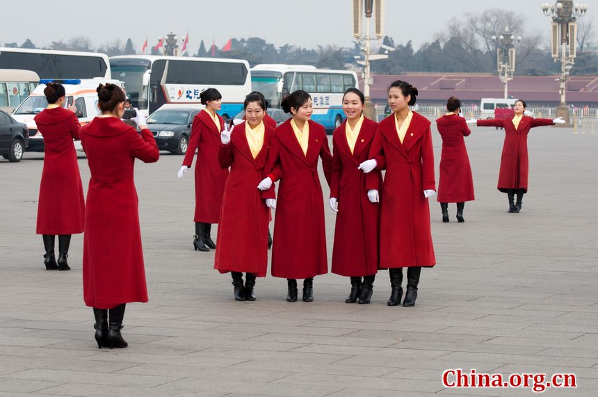 Hotel staff members serving the delegations to the National People's Congress (NPC) pose for photos at the Tian'anmen Square on Sunday, March 4, 2012, in Beijing, China, one day prior to the NPC's opening ceremony on the morning of March 5 at the Great Hall of the People. [China.org.cn]