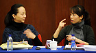 Tai Lihua (L), a member of the 11th National Committee of the Chinese People's Political Consultative Conference (CPPCC), joins in a panel discussion of the Fifth Session of the 11th CPPCC National Committee with the help of a sign language interpreter in Beijing, capital of China, March 4, 2012.