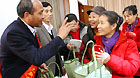 NPC Deputy Chen Fei (left) presents bamboo baskets to representatives from the Women and Children Social Service Center in Beijing on Sunday.