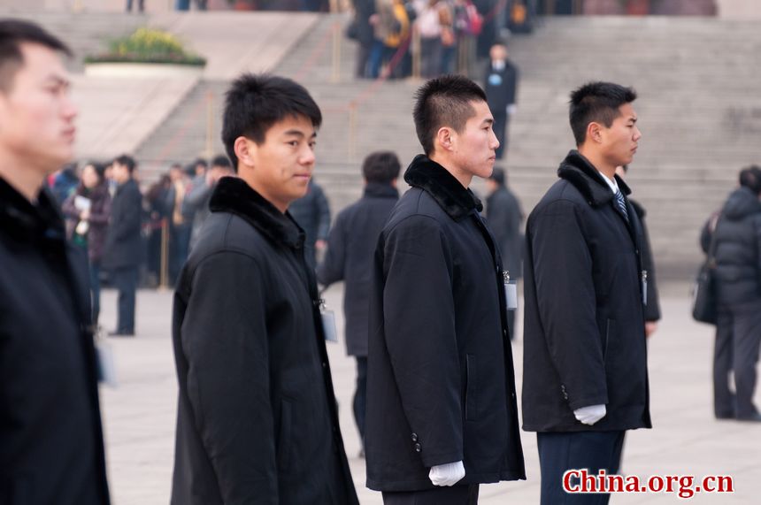 Security staff members line up at the entrance to the Great Hall of the People in Beijing, China, on Sunday, March 4, 2012 as delegates to the congress and journalists covering the events queue to enter the venue. [China.org.cn]