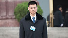 A security officer stands on duty at the entrance to the Great Hall of the People in Beijing, China, on Sunday, March 4, 2012 as delegates to the congress and journalists covering the events queue to enter the venue.